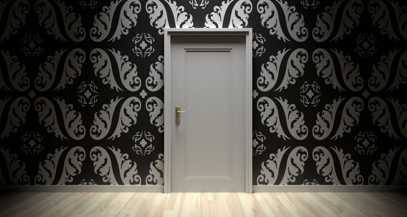 A coloured door in a plain wall