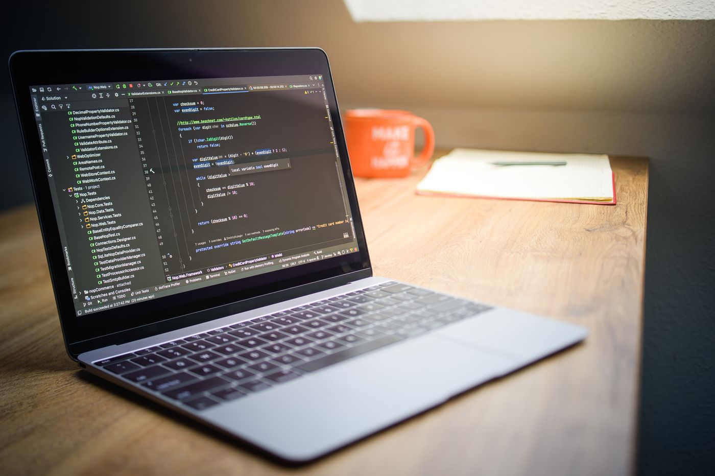 Laptop showing code on a tidy desk
